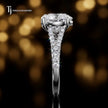Side profile of a heart cut split shank lab-grown diamond engagement ring with diamond-set shoulders in 18kt white gold.