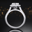 Side view of a marquise cut halo lab-grown diamond engagement ring with diamond-set shoulders in 18kt white gold.