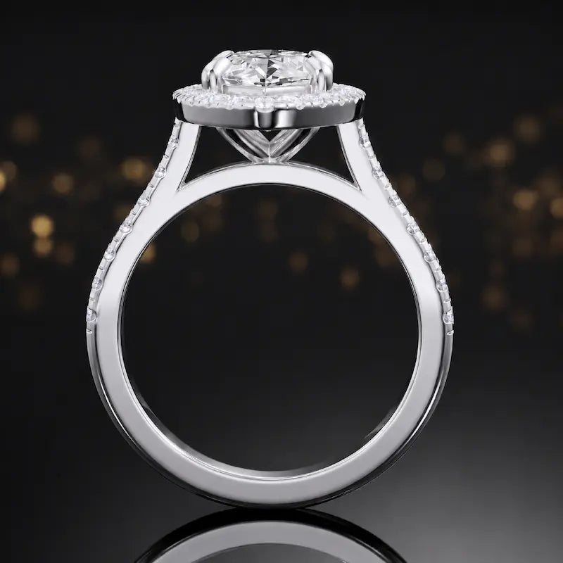 Side view of a marquise cut halo lab-grown diamond engagement ring with diamond-set shoulders in 18kt white gold.
