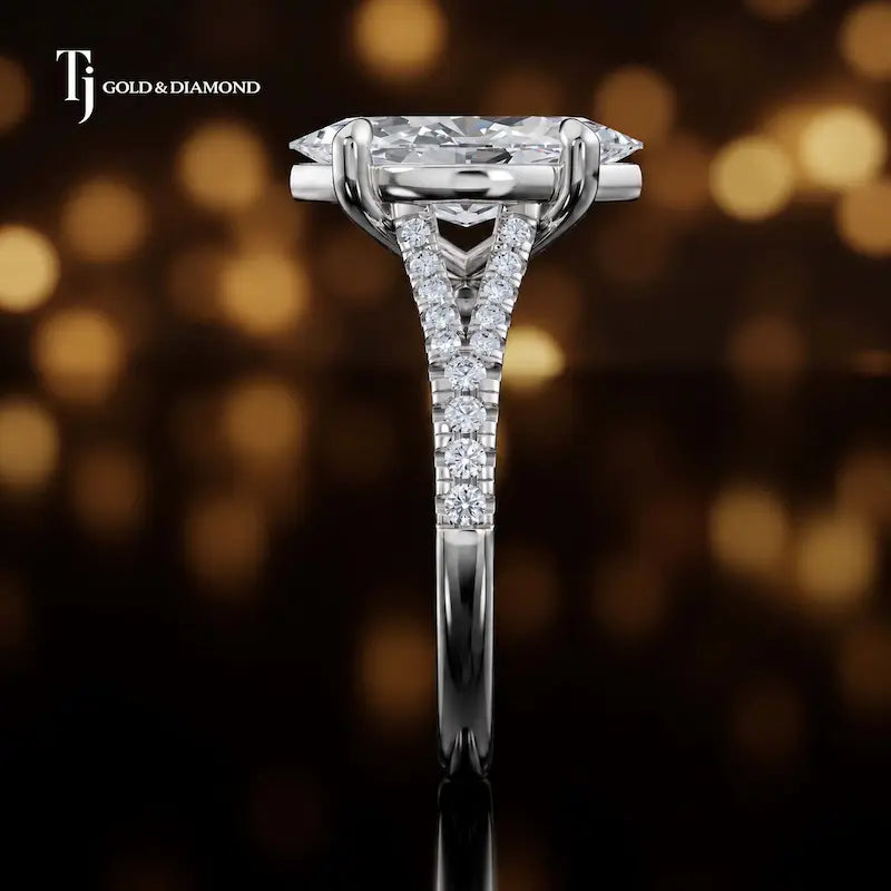 Side profile of a marquise cut split shank lab-grown diamond engagement ring with diamond-set shoulders in 18kt white gold.