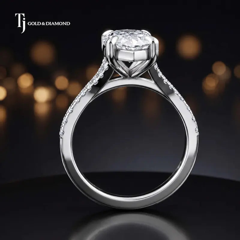 Side view of a marquise cut split shank lab-grown diamond engagement ring featuring a four-claw cathedral setting in 18kt white gold.