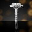 Side profile of an oval cut halo lab-grown diamond engagement ring in 18kt white gold.