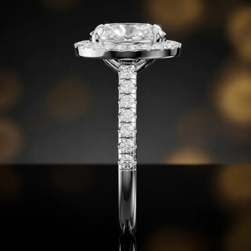 Side profile of an oval cut halo lab-grown diamond engagement ring in 18kt white gold.