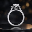 Side view of an oval cut halo lab-grown diamond engagement ring with diamond-set shoulders in 18kt white gold.