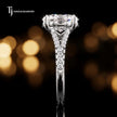 Side profile of an oval cut split shank lab-grown diamond engagement ring with diamond-set shoulders in 18kt white gold.