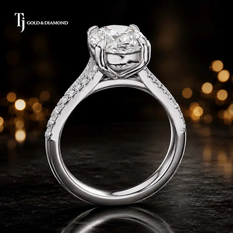 Side view of an oval cut split shank lab-grown diamond engagement ring featuring a four-claw cathedral setting in 18kt white gold.