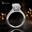 Side view of an oval cut split shank lab-grown diamond engagement ring featuring a four-claw cathedral setting in 18kt white gold.