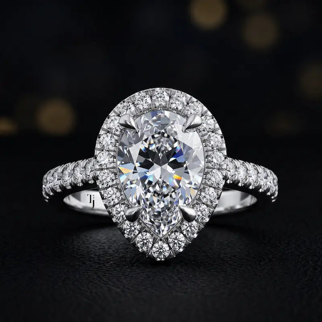 Front view of a pear cut halo lab-grown diamond engagement ring in 18kt white gold.