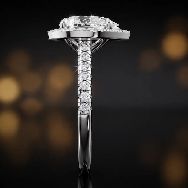 Side profile of a pear cut halo lab-grown diamond engagement ring in 18kt white gold.