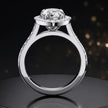 Side view of a pear cut halo lab-grown diamond engagement ring with diamond-set shoulders in 18kt white gold.