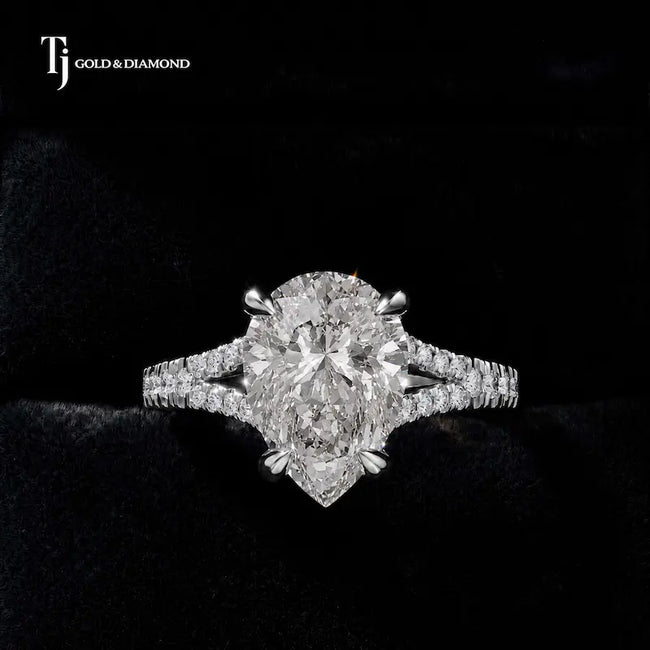 Front view of a pear cut split shank lab-grown diamond engagement ring in 18kt white gold.