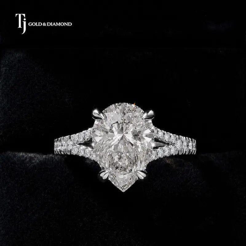 Front view of a pear cut split shank lab-grown diamond engagement ring in 18kt white gold.