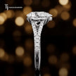 Side profile of a pear cut split shank lab-grown diamond engagement ring with diamond-set shoulders in 18kt white gold.
