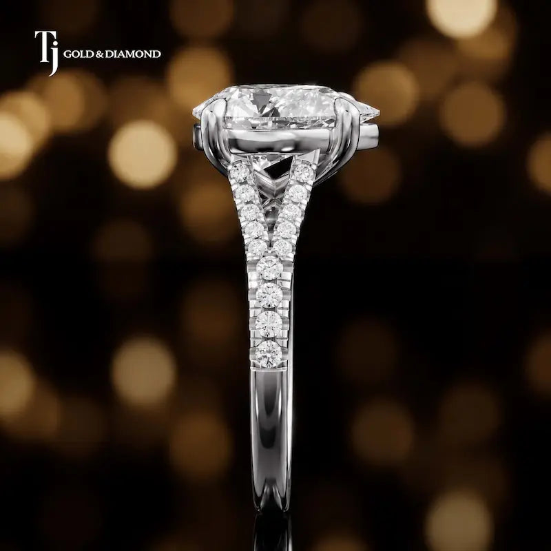 Side profile of a pear cut split shank lab-grown diamond engagement ring with diamond-set shoulders in 18kt white gold.