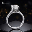 Side view of a pear cut split shank lab-grown diamond engagement ring featuring a four-claw cathedral setting in 18kt white gold.