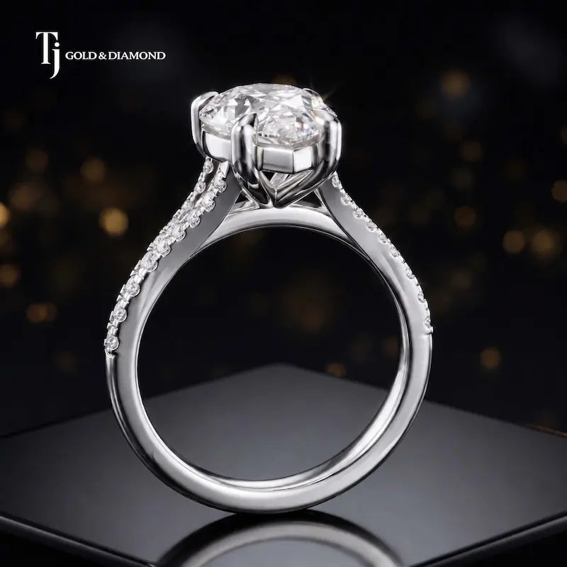 Side view of a pear cut split shank lab-grown diamond engagement ring featuring a four-claw cathedral setting in 18kt white gold.