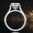 Side view of a princess cut halo lab-grown diamond engagement ring with diamond-set shoulders in 18kt white gold.