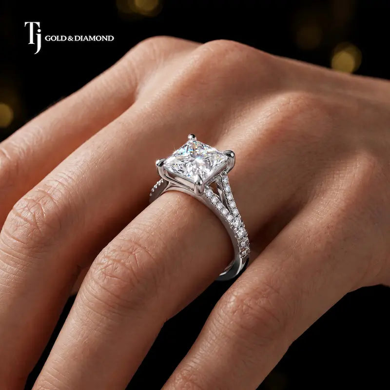 Princess cut split shank lab-grown diamond engagement ring worn on hand in 18kt white gold.
