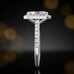 Side profile of a radiant cut halo lab-grown diamond engagement ring in 18kt white gold.