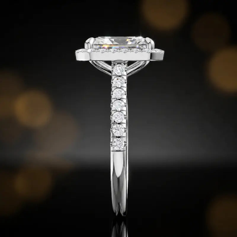 Side profile of a radiant cut halo lab-grown diamond engagement ring in 18kt white gold.