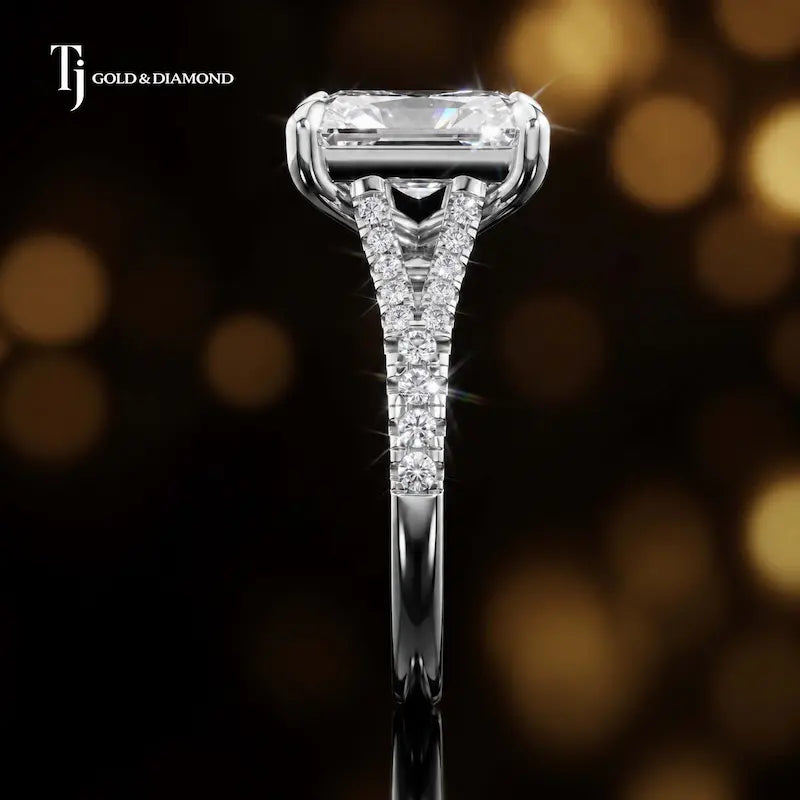 Side profile of a radiant cut split shank lab-grown diamond engagement ring with diamond-set shoulders in 18kt white gold.