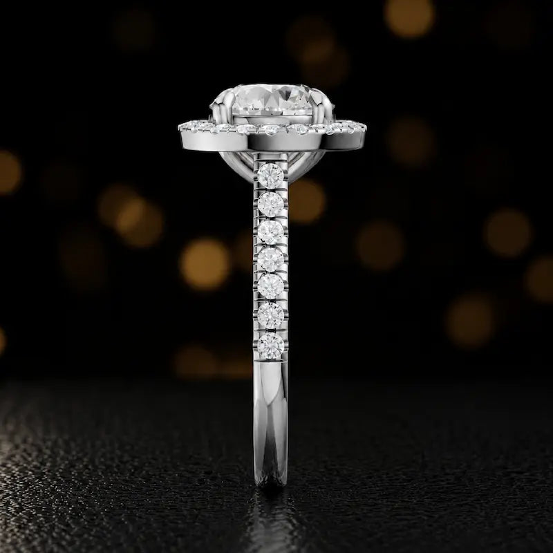 Side profile of a round cut halo lab-grown diamond engagement ring in 18kt white gold.