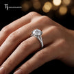 Round cut split shank lab-grown diamond engagement ring worn on hand in 18kt white gold.