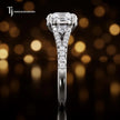Side profile of a round cut split shank lab-grown diamond engagement ring with diamond-set shoulders in 18kt white gold.