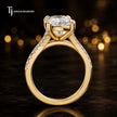 Side view of a cushion cut split shank lab-grown diamond engagement ring featuring a four-claw cathedral setting in 18kt yellow gold.