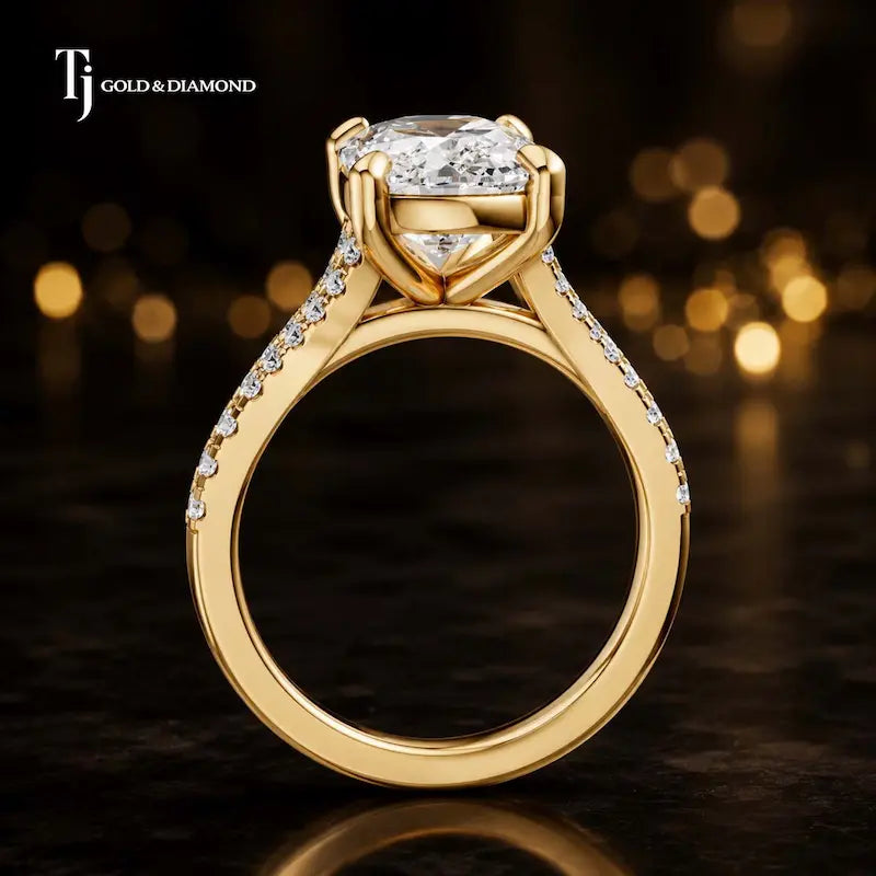 Side view of a cushion cut split shank lab-grown diamond engagement ring featuring a four-claw cathedral setting in 18kt yellow gold.