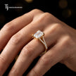 Emerald cut split shank lab-grown diamond engagement ring worn on hand in 18kt yellow gold.