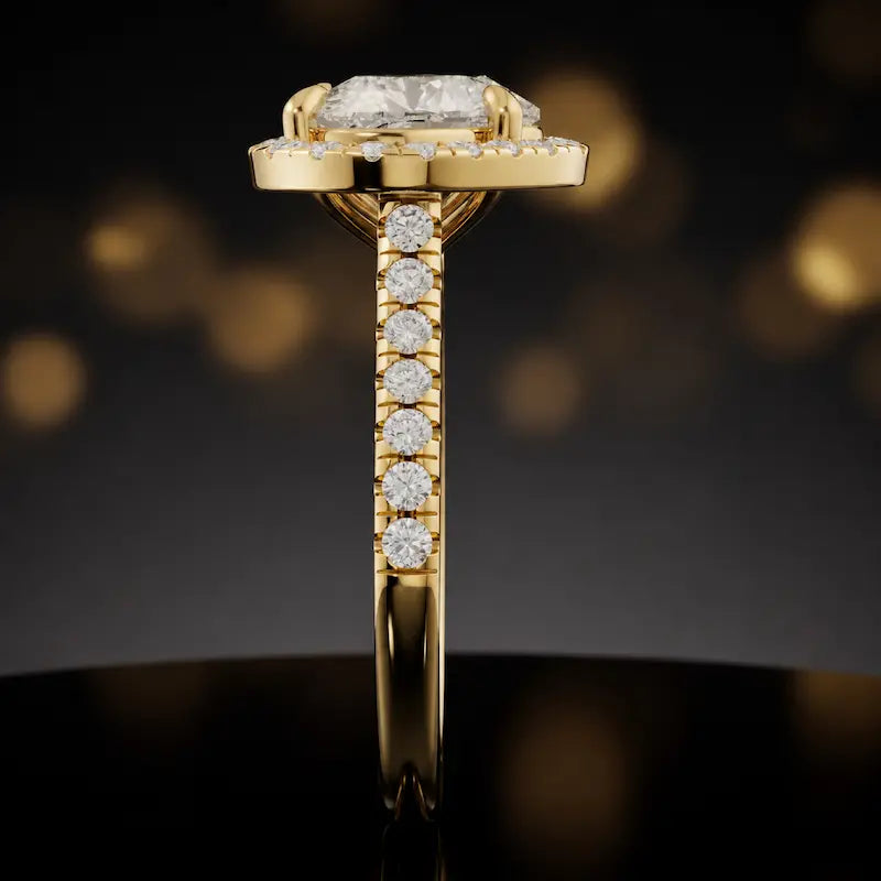 Side profile of a heart cut halo lab-grown diamond engagement ring in 18kt yellow gold.