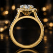 Side view of a heart cut halo lab-grown diamond engagement ring with diamond-set shoulders in 18kt yellow gold.