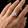 Heart cut halo lab-grown diamond engagement ring worn on hand in 18kt yellow gold.
