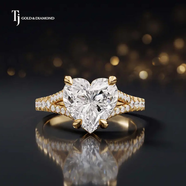 Front view of a heart cut split shank lab-grown diamond engagement ring in 18kt yellow gold.