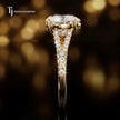 Side profile of a heart cut split shank lab-grown diamond engagement ring with diamond-set shoulders in 18kt yellow gold.