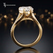 Side view of a heart cut split shank lab-grown diamond engagement ring featuring a four-claw cathedral setting in 18kt yellow gold.