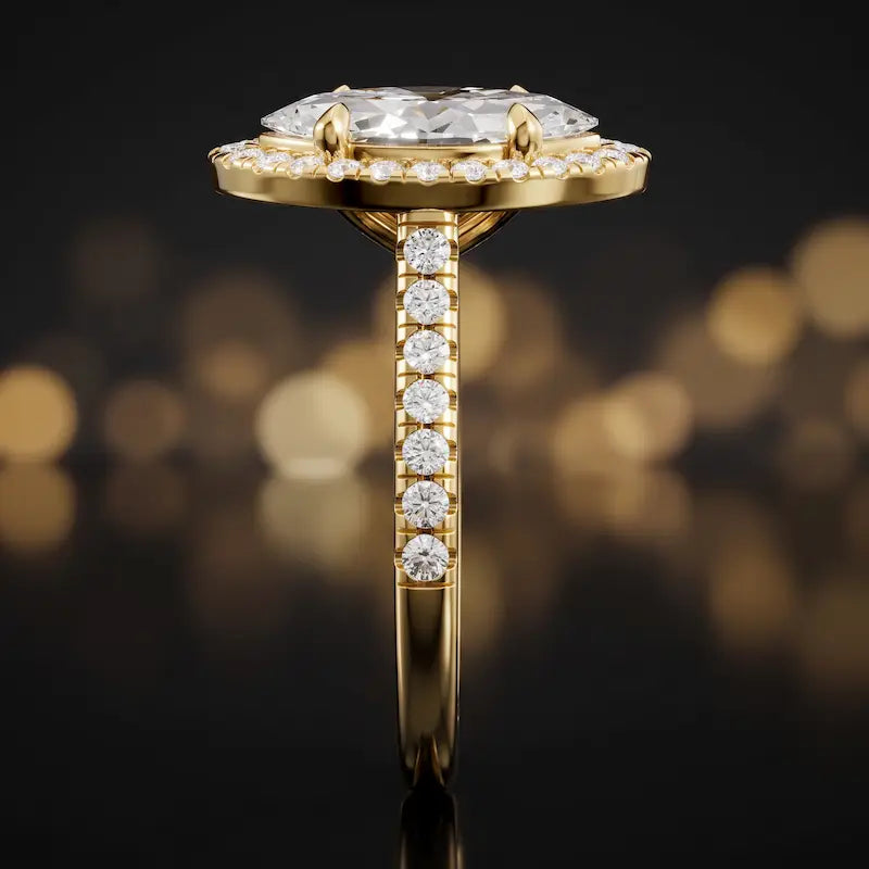 Side profile of a marquise cut halo lab-grown diamond engagement ring in 18kt yellow gold.