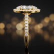Side profile of a marquise cut halo lab-grown diamond engagement ring in 18kt yellow gold.