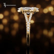 Side profile of a marquise cut split shank lab-grown diamond engagement ring with diamond-set shoulders in 18kt yellow gold.