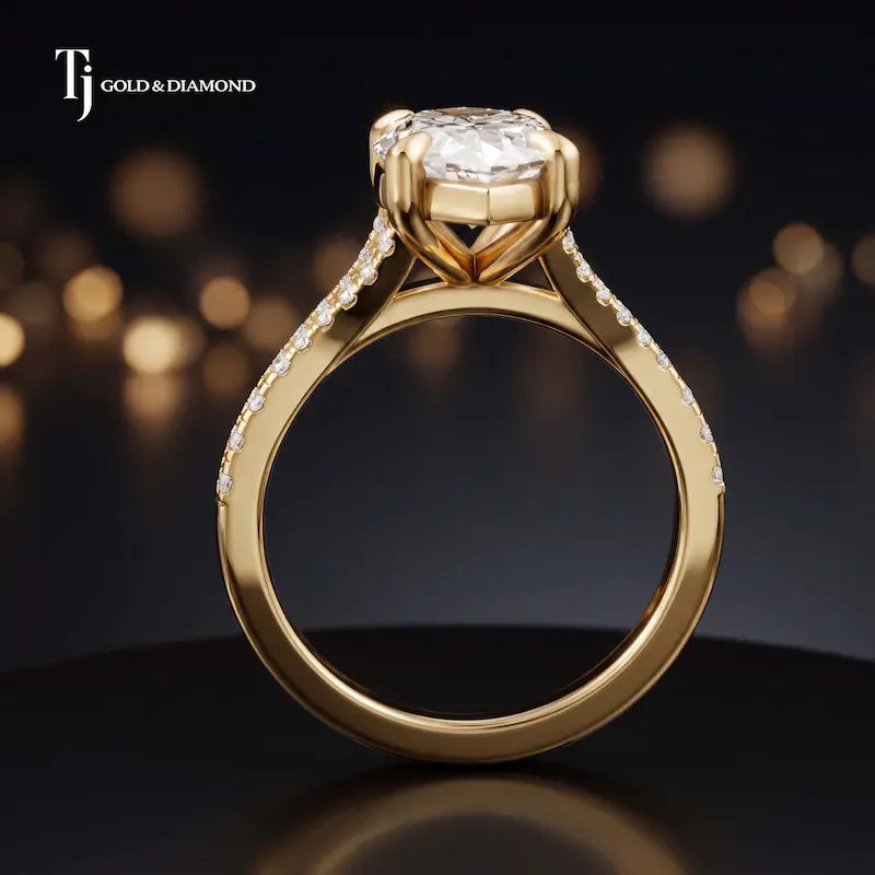 Side view of a marquise cut split shank lab-grown diamond engagement ring featuring a four-claw cathedral setting in 18kt yellow gold.