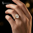 Oval cut split shank lab-grown diamond engagement ring worn on hand in 18kt yellow gold.
