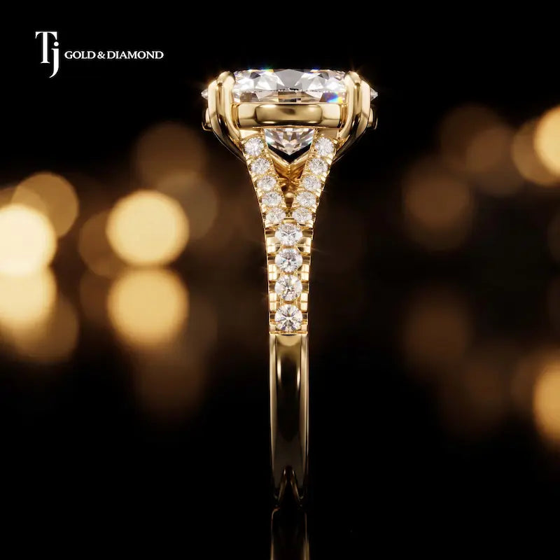 Side profile of an oval cut split shank lab-grown diamond engagement ring with diamond-set shoulders in 18kt yellow gold.