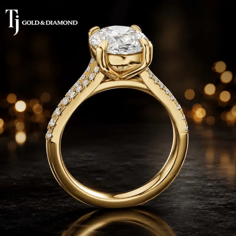 Side view of an oval cut split shank lab-grown diamond engagement ring featuring a four-claw cathedral setting in 18kt yellow gold.