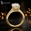 Side view of an oval cut split shank lab-grown diamond engagement ring featuring a four-claw cathedral setting in 18kt yellow gold.