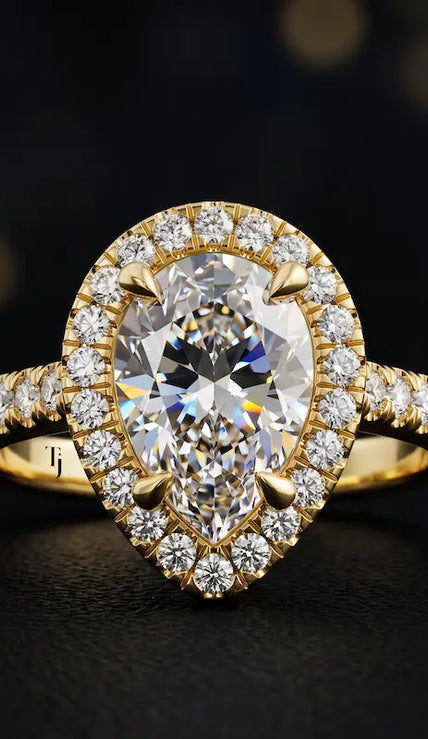 Front view of a pear cut halo lab-grown diamond engagement ring in 18kt yellow gold.