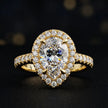 Front view of a pear cut halo lab-grown diamond engagement ring in 18kt yellow gold.