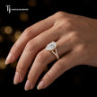 Pear cut split shank lab-grown diamond engagement ring worn on hand in 18kt yellow gold.