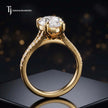Side view of a pear cut split shank lab-grown diamond engagement ring featuring a four-claw cathedral setting in 18kt yellow gold.