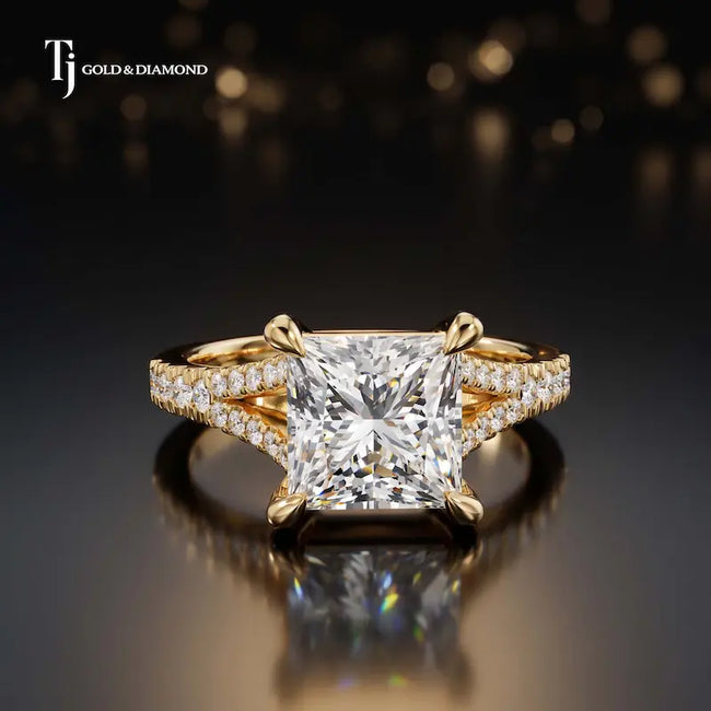 Front view of a princess cut split shank lab-grown diamond engagement ring in 18kt yellow gold.